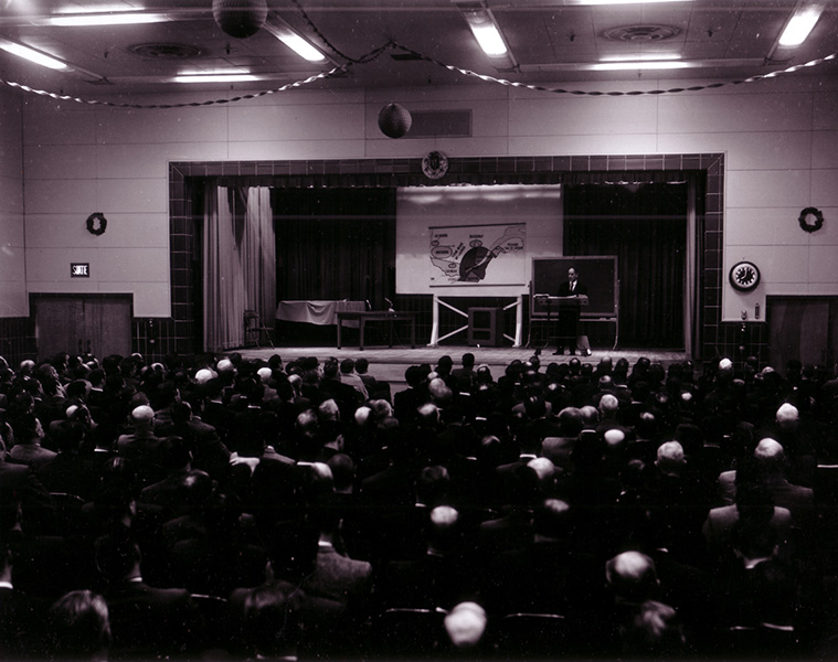 René Lévesque on stage explaining his nationalization project for electricity